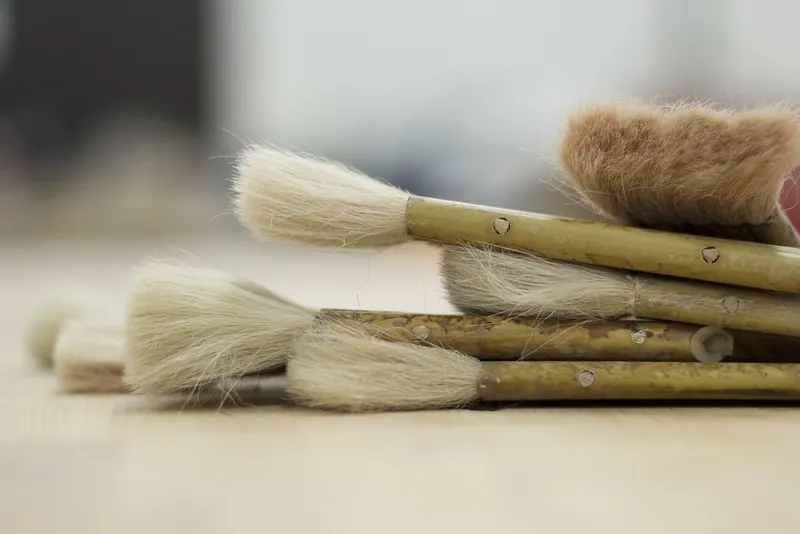 Kwasten met lichte haren op een houten werkblad